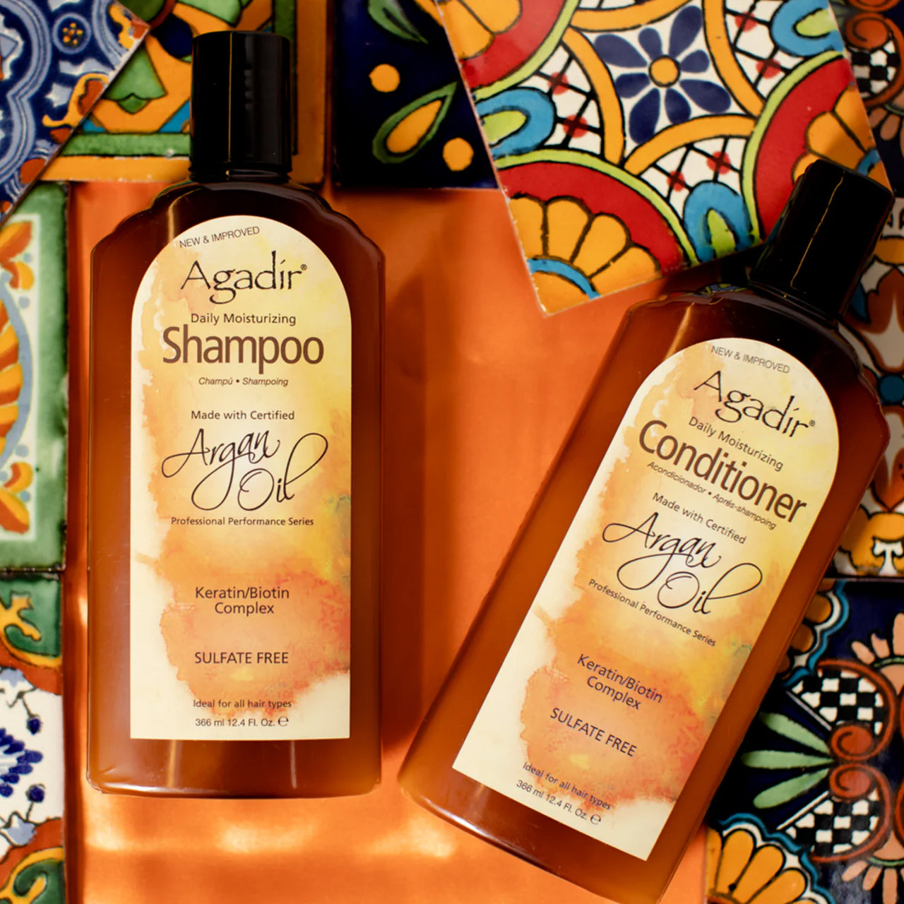 Agadir Argan Oil Daily Moisturising Conditioner 355ml bottle next to argan nuts and oil, highlighting natural ingredients.