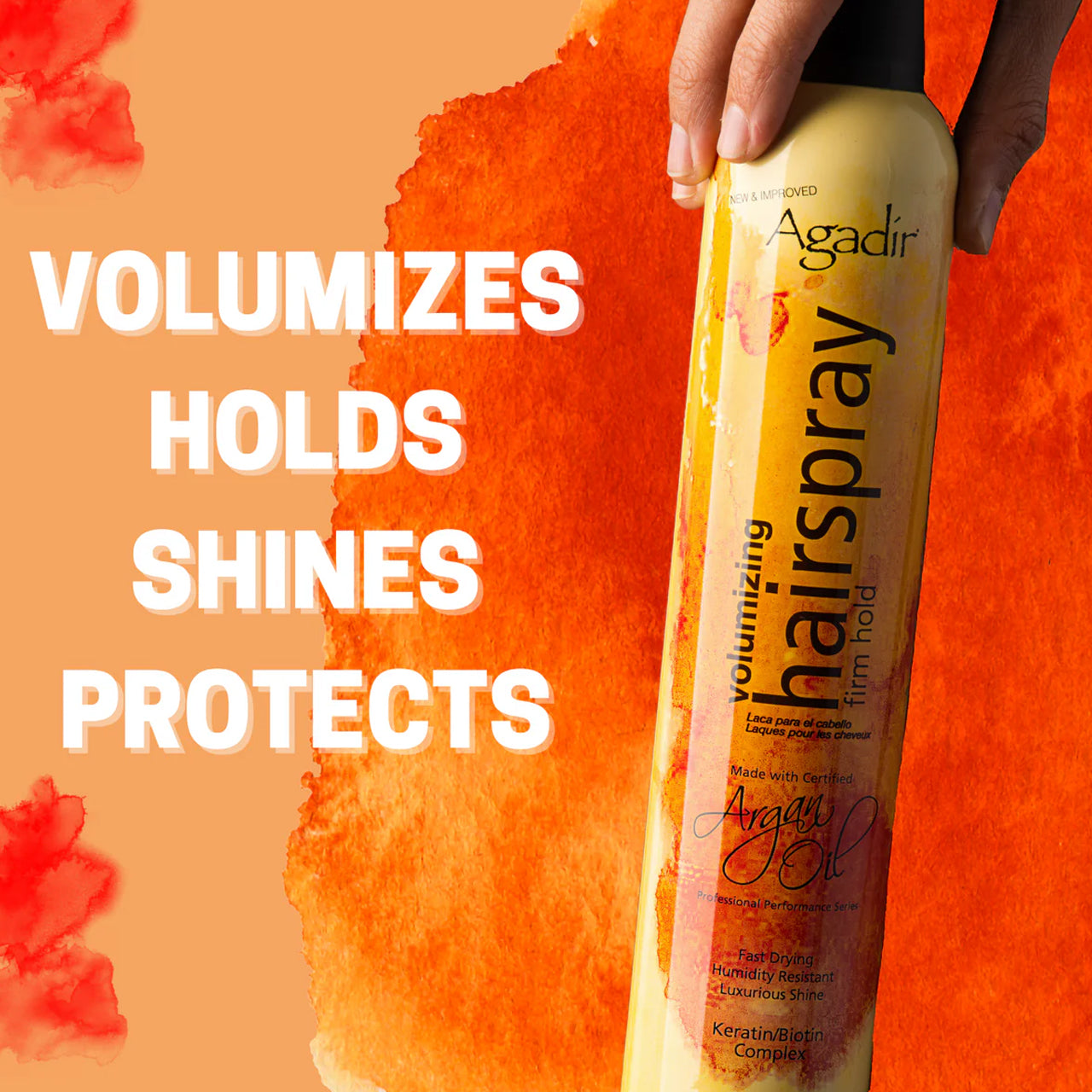 Hairstylist applying Agadir Argan Oil Volumising Hair Spray to a model's hair for added volume.