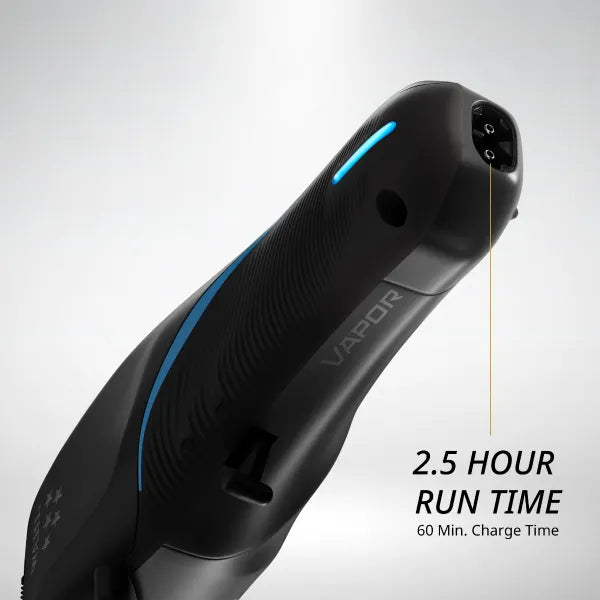 Barber using the Wahl Vapor Cordless Clipper to achieve a precise fade haircut.